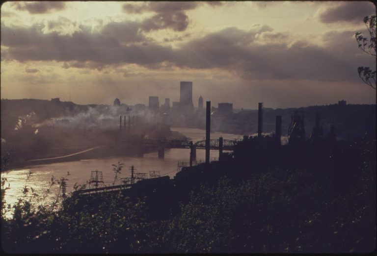 Clean Air Zones Reviewed as Traffic Patterns Shift city skyline visible through hazy air