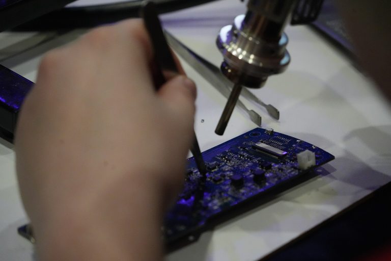 Neuromorphic Chips Bring AI to the Edge A close-up photograph of a microchip and circuit board.