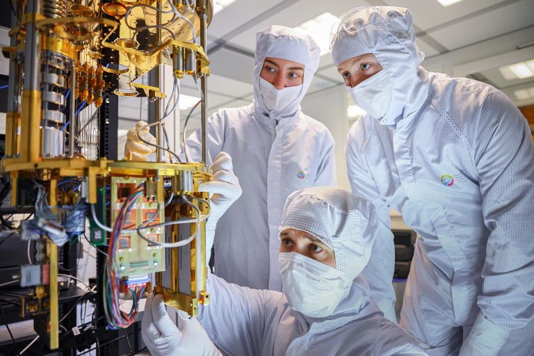 A quantum computer's cryostat and processor assembly inside a research laboratory.